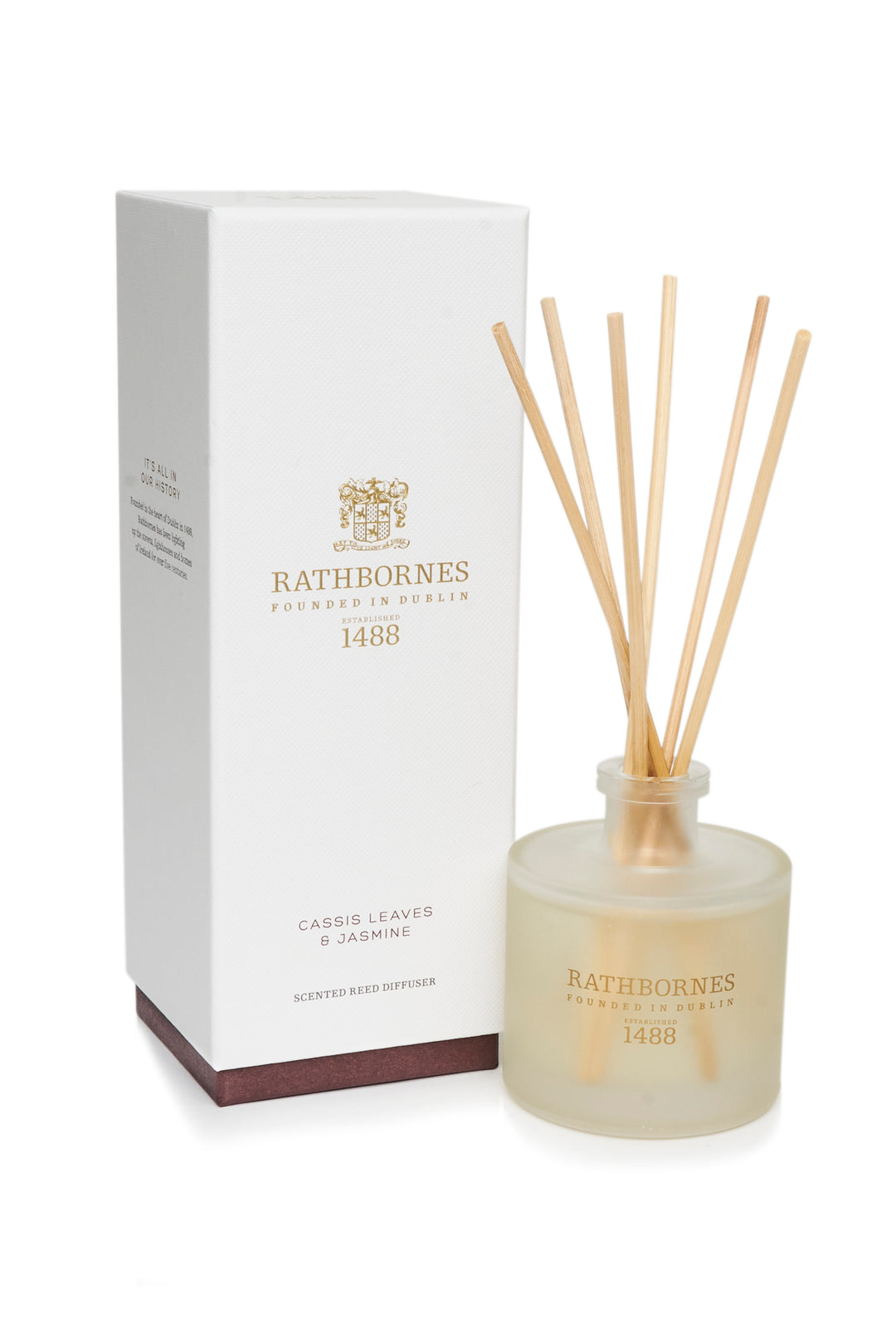 A Rathbones branded reed diffuser with cassis leaves and jasmine fragrance, including reed sticks and a bottle, displayed next to its packaging box.