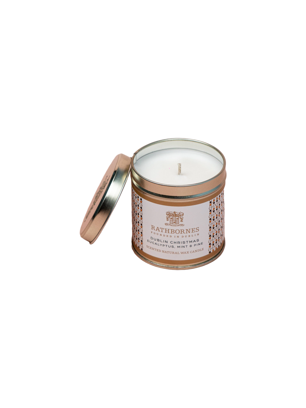 A scented natural wax candle in a tin with a Christmas design, featuring a label and a lid.