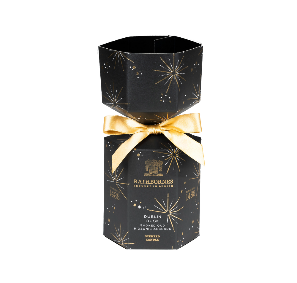 Black hexagonal candle box with gold bow and Rathborne's branding with no background