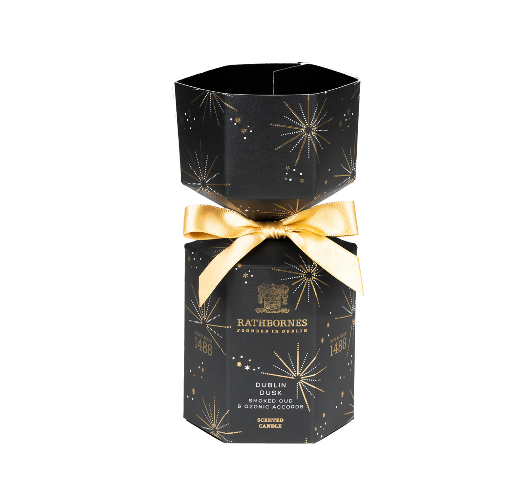 Black hexagonal candle box with gold bow and Rathborne's branding with no background