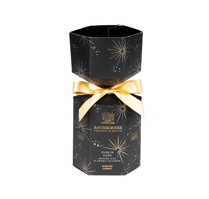 Black hexagonal candle box with gold bow and Rathborne's branding with no background