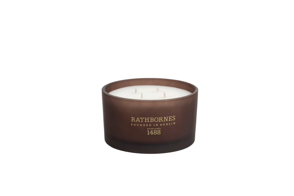 Brown candle with 'Rathbornes' branding with transparent background