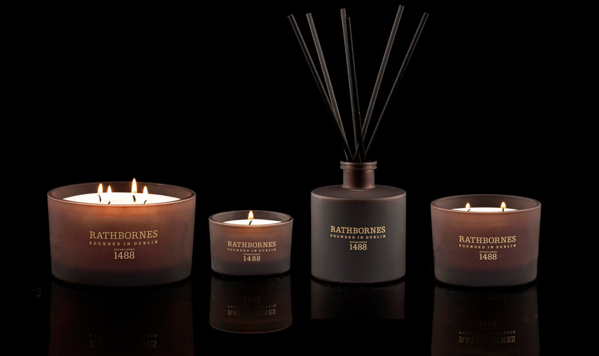 Rathborne's candles and diffuser on a black background