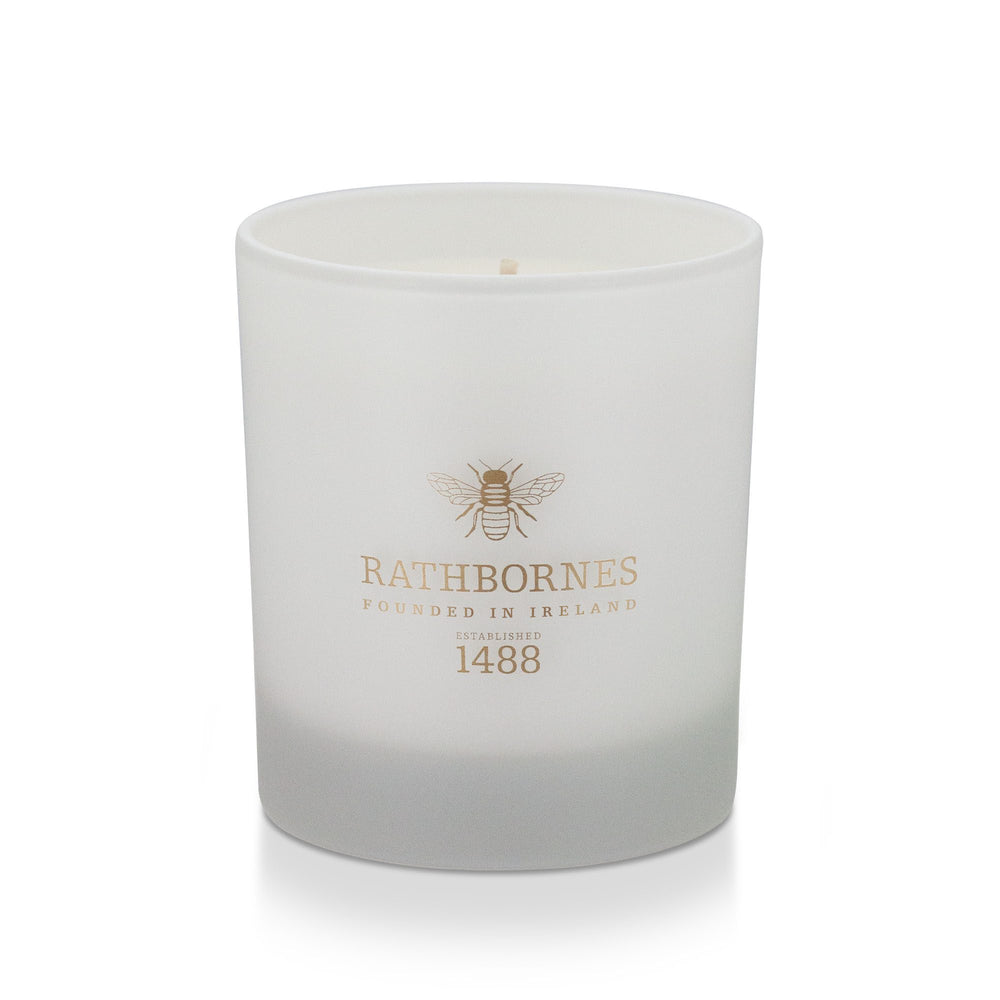 Rathbornes Herbal Woods scented candle in frosted white glass with gold bee motif