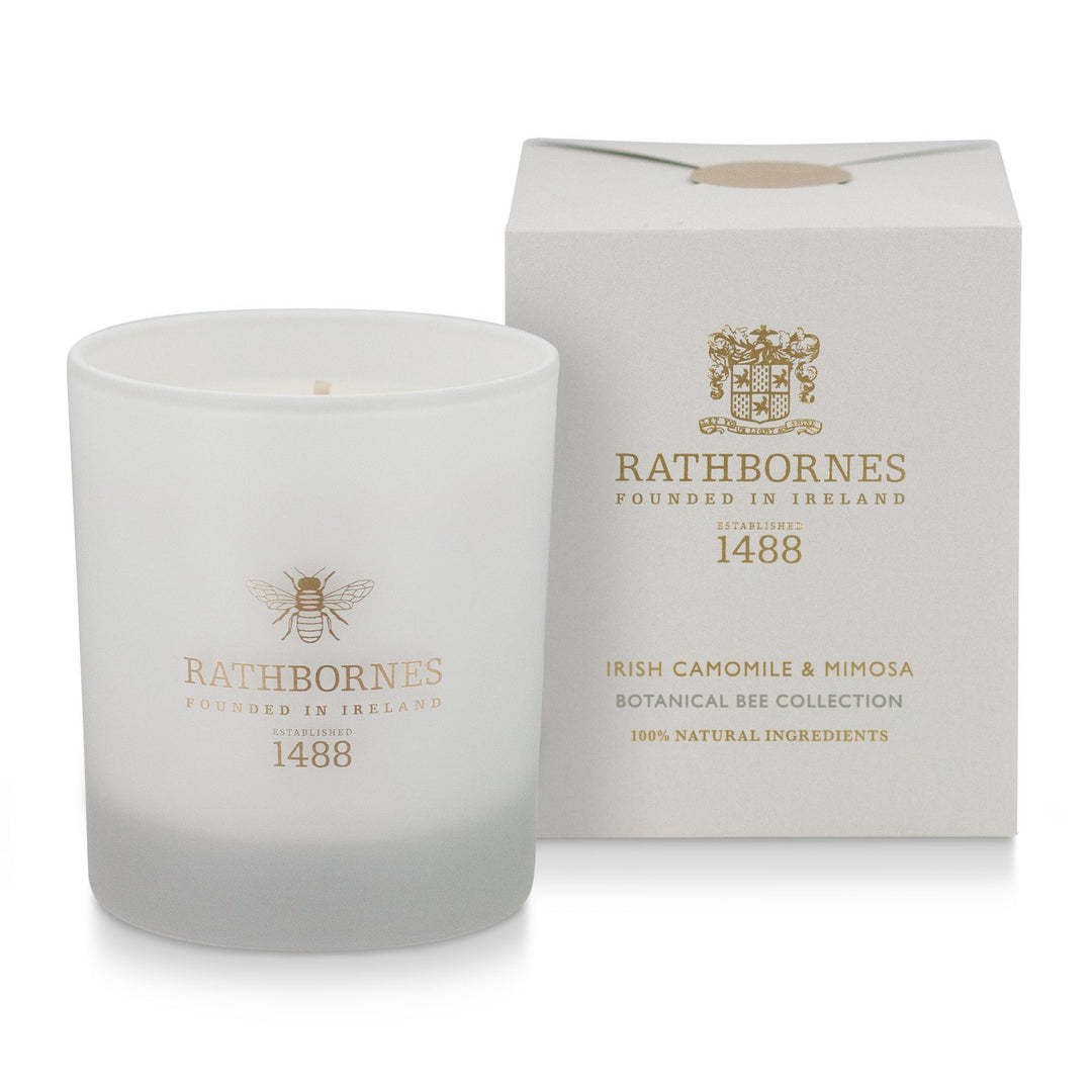 Rathbornes Irish Camomile & Mimosa scented candle beside its stone colour gift box