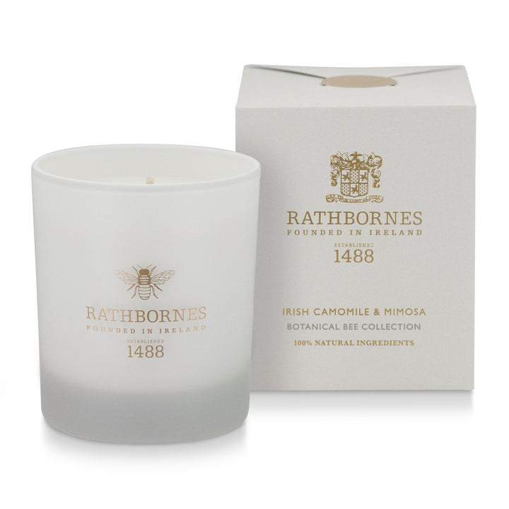 Rathbornes Irish Camomile & Mimosa scented candle beside its stone colour gift box