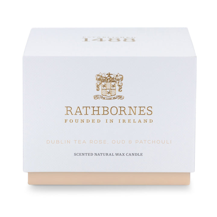 Rathbornes Dublin Tea Rose, Oud & Patchouli classic scented candle beside its white gift box with blush base