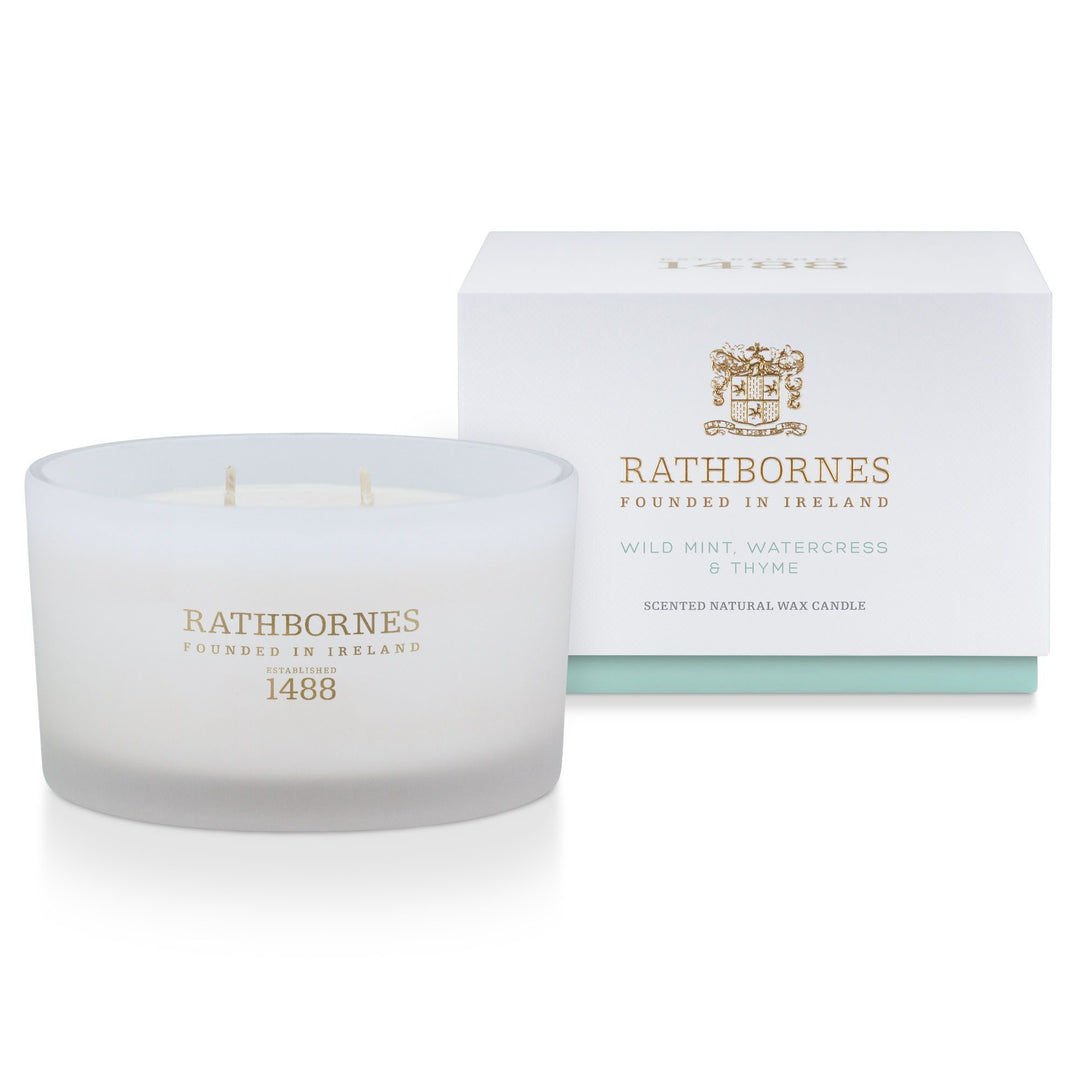 Rathbornes Wild Mint, Watercress & Thyme luxury 4 wick scented candle beside its white gift box with mint-green base