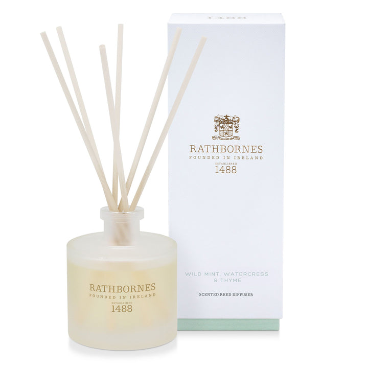 Rathbornes Wild Mint, Watercress & Thyme scented reed diffuser with reeds, beside its gift box