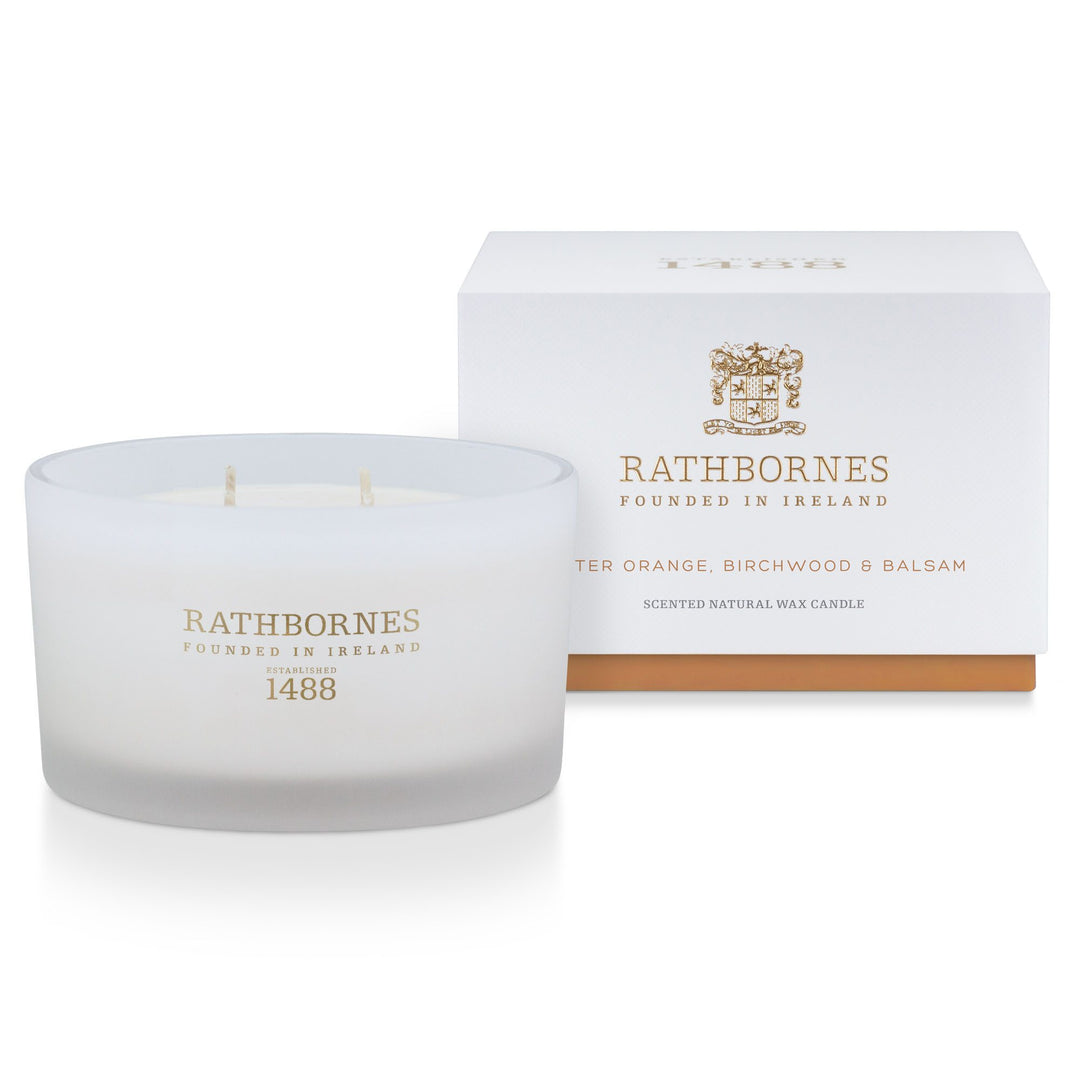 Rathbornes Bitter Orange, Birch Tar & Balsam luxury scented candle beside its white gift box with amber base