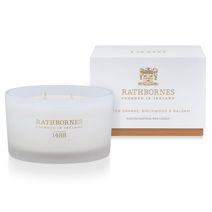 Rathbornes Bitter Orange, Birch Tar & Balsam luxury scented candle beside its white gift box with amber base