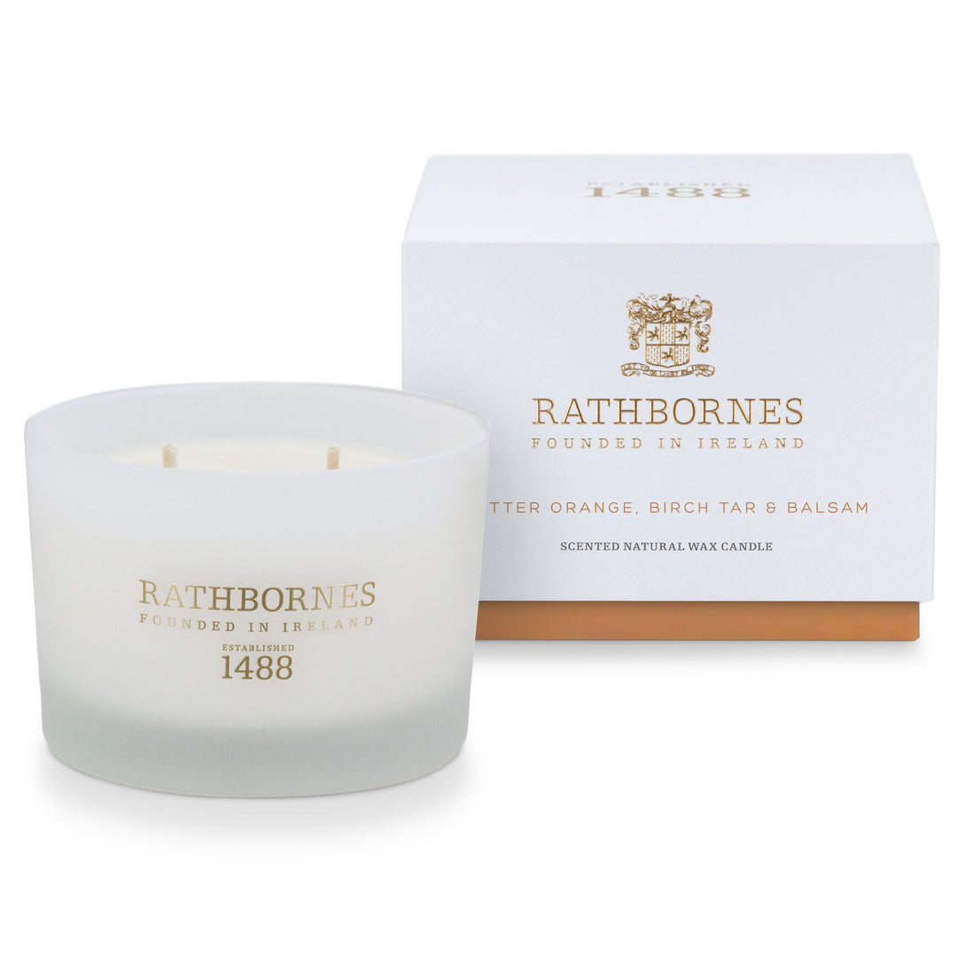 Rathbornes Bitter Orange, Birch Tar & Balsam classic scented candle beside its white gift box with amber base