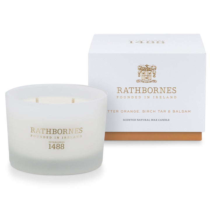 Rathbornes Bitter Orange, Birch Tar & Balsam classic scented candle beside its white gift box with amber base