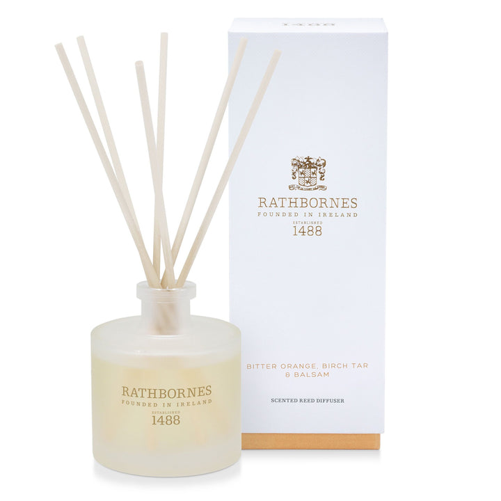 Rathbornes Bitter Orange, Birch Tar & Balsam scented reed diffuser with reeds, beside its gift box
