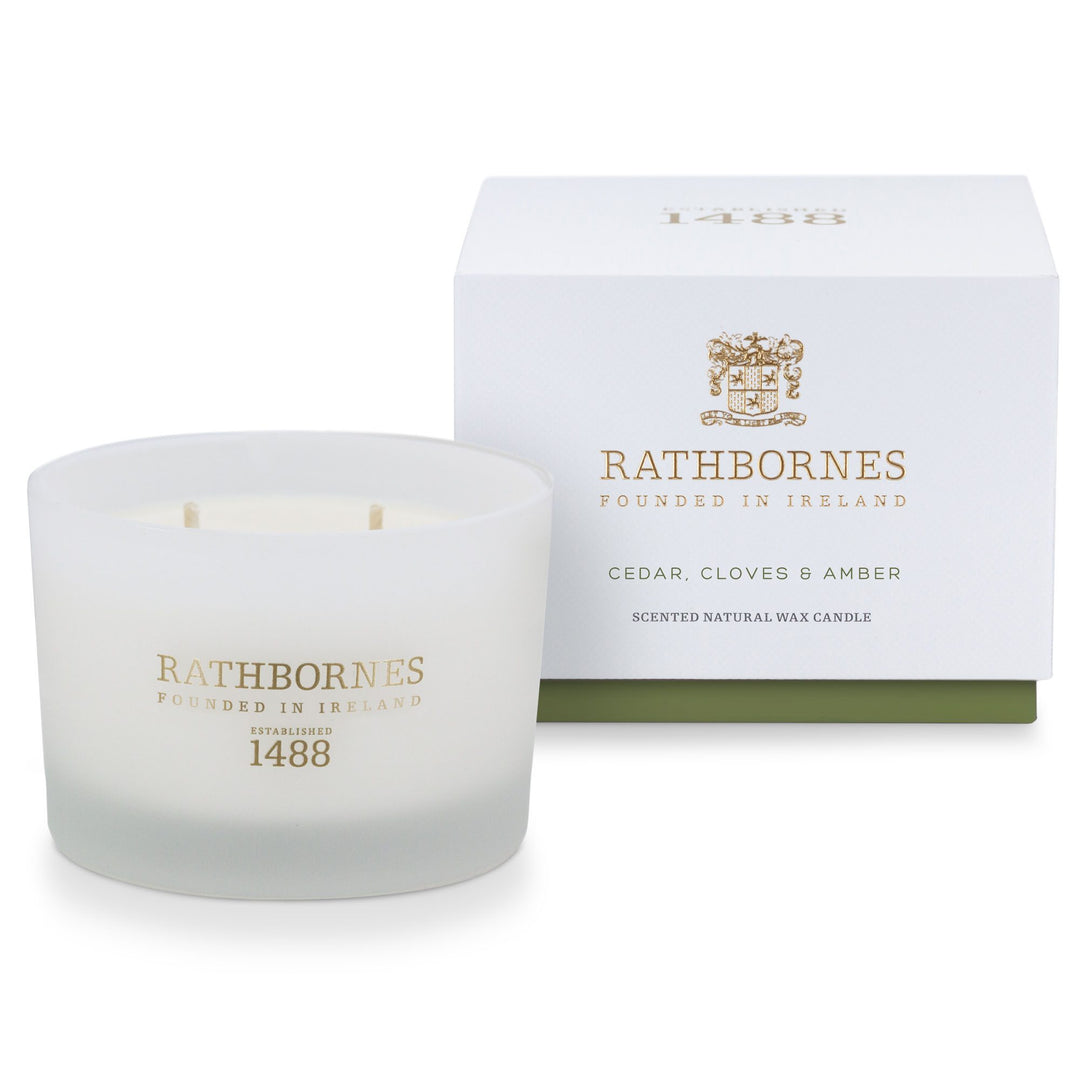 Rathbornes Cedar, Cloves & Amber classic scented candle beside its white gift box with green base