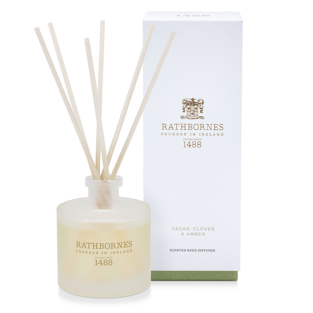 Rathbornes Cedar, Cloves & Amber scented reed diffuser with reeds, beside its gift box