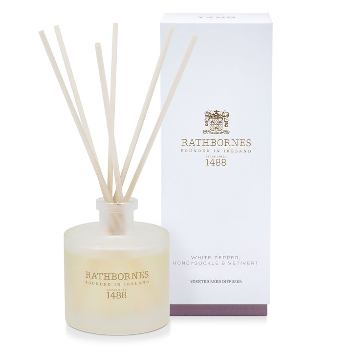 Rathbornes White Pepper, Honeysuckle & Vetivert scented reed diffuser with reeds, beside its gift box