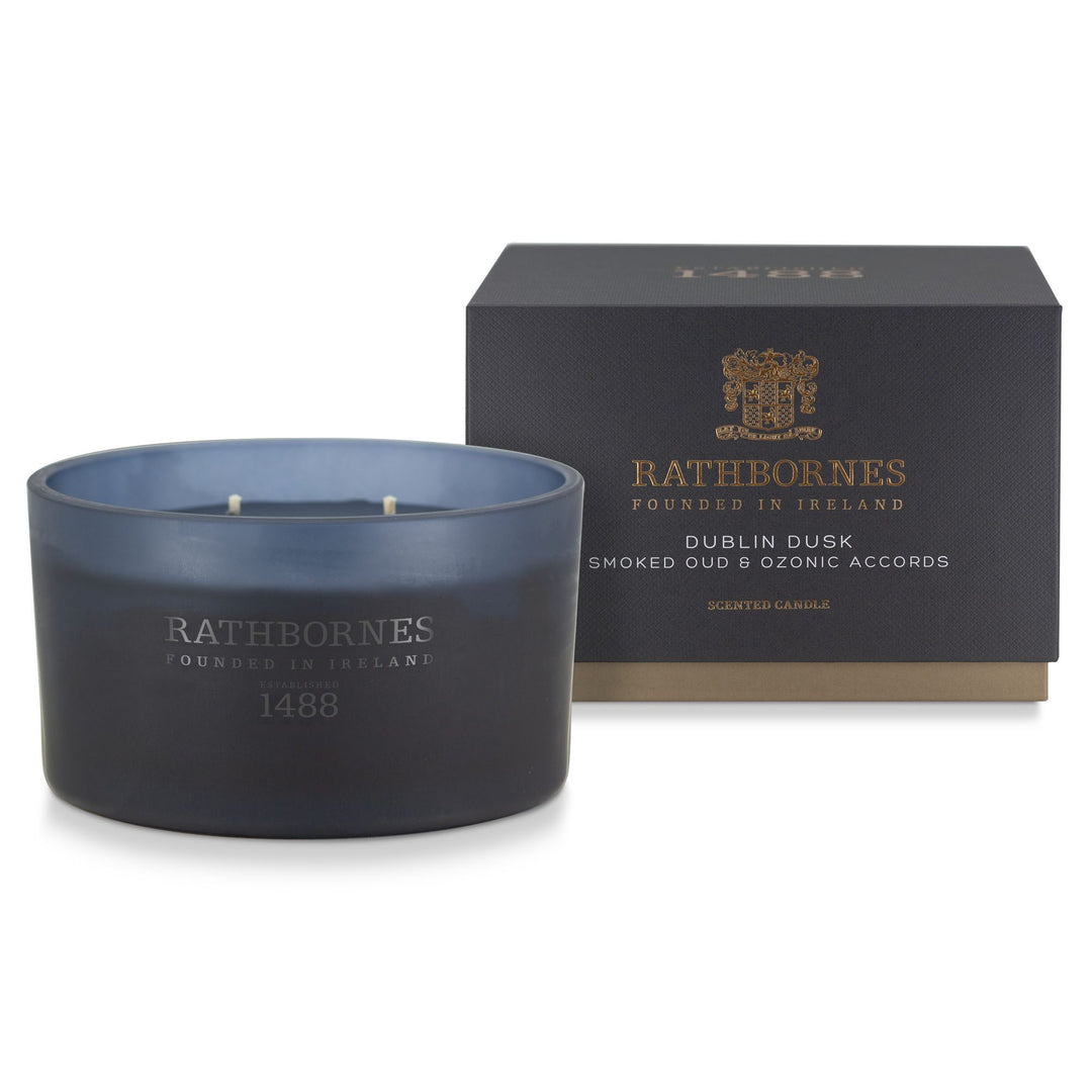 Rathbornes Dublin Dusk (Smoked Oud & Ozonic Accords) luxury scented candle beside its deep navy gift box