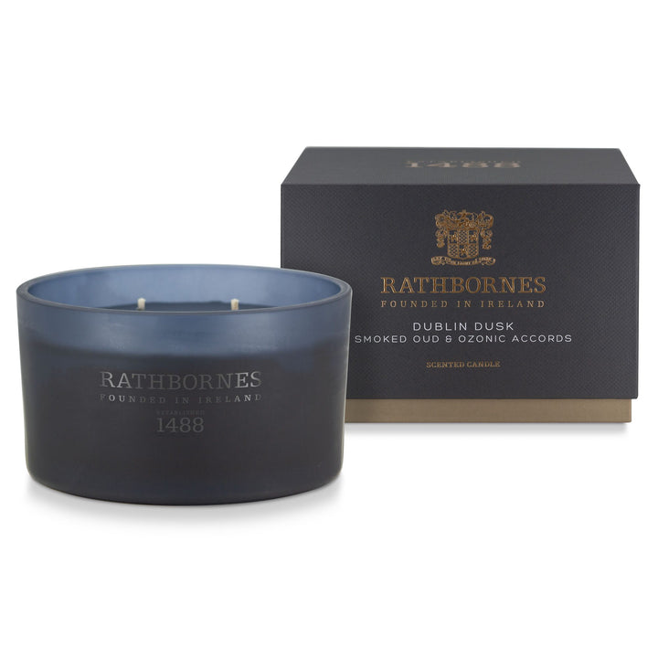 Rathbornes Dublin Dusk (Smoked Oud & Ozonic Accords) luxury scented candle beside its deep navy gift box