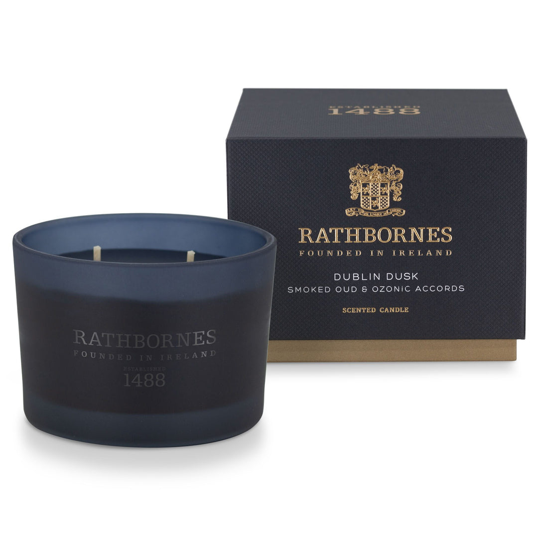Rathbornes Dublin Dusk (Smoked Oud & Ozonic Accords) classic scented candle beside its deep navy gift box