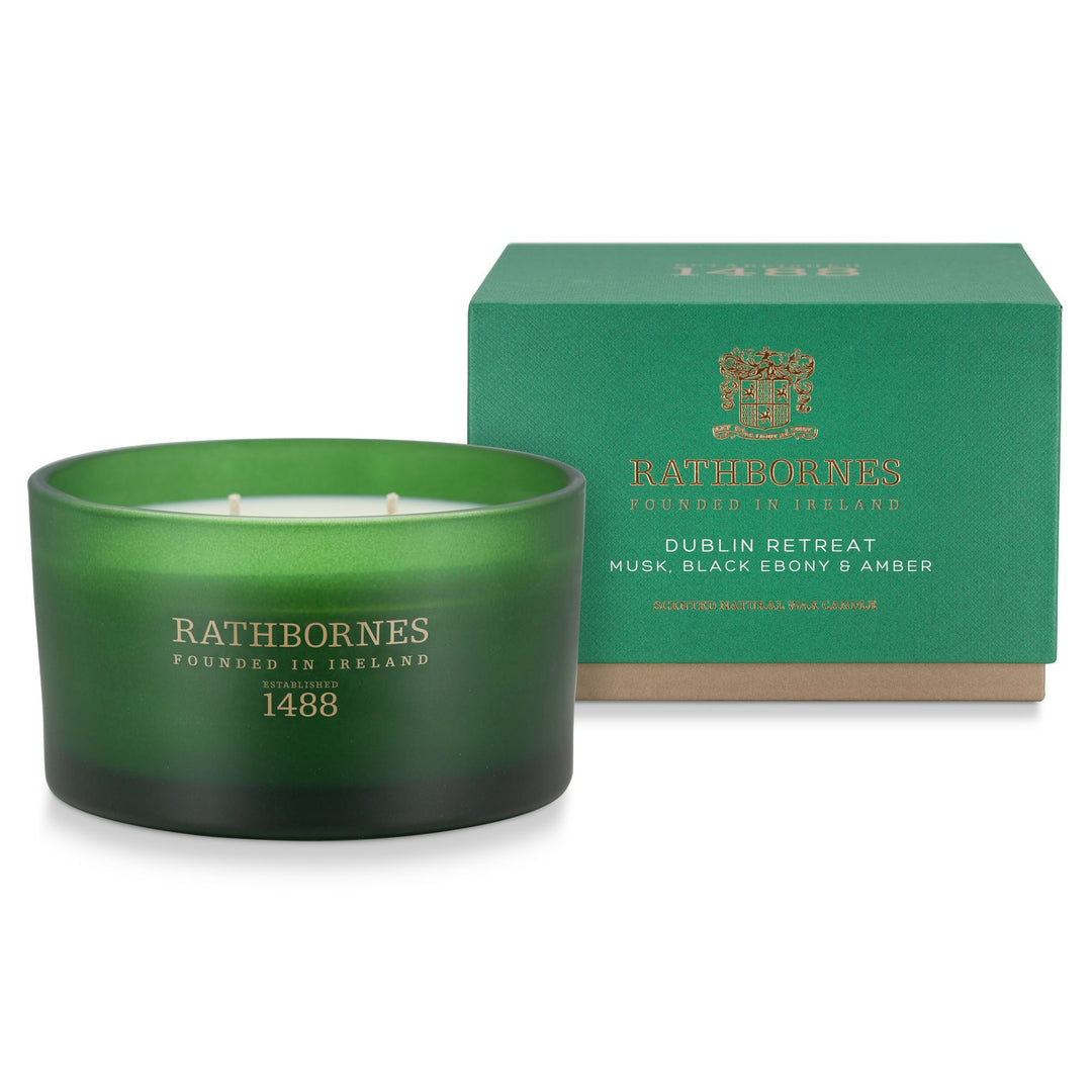 Rathbornes Dublin Retreat (Musk, Black Ebony & Amber) luxury scented candle beside its emerald green gift box