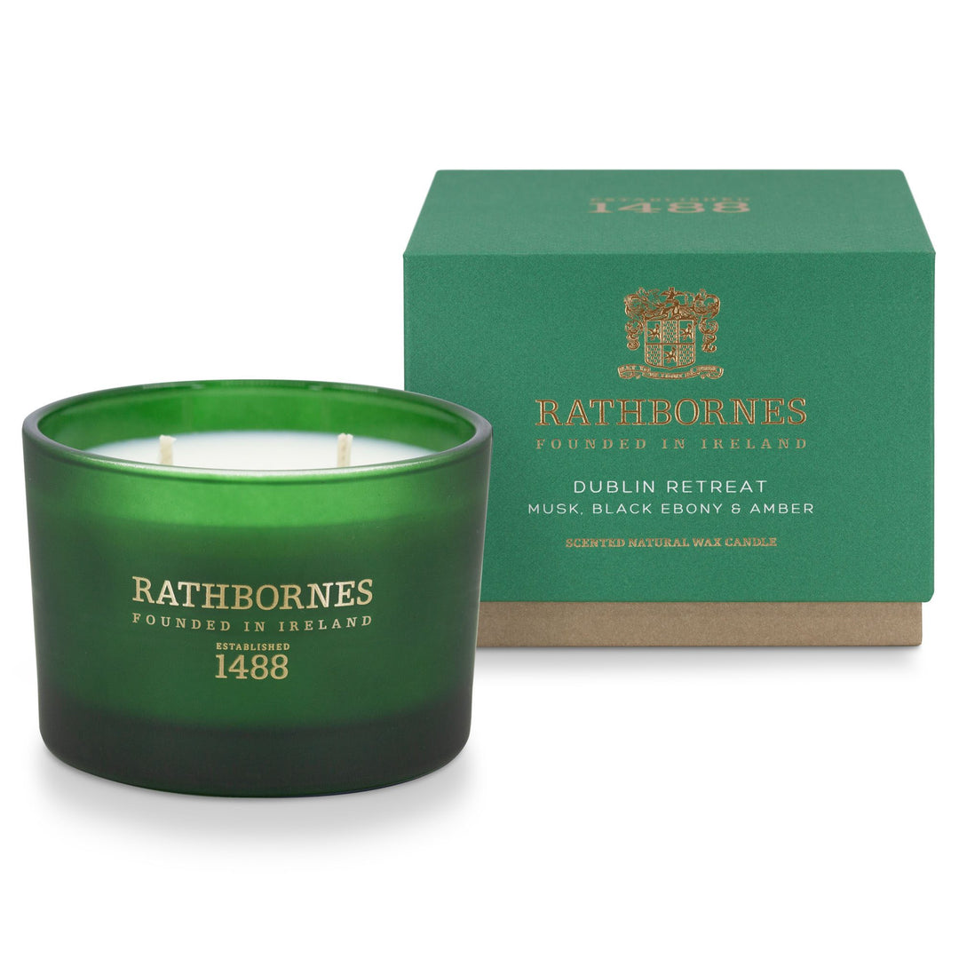 Rathbornes Dublin Retreat (Musk, Black Ebony & Amber) classic scented candle beside its emerald green gift box