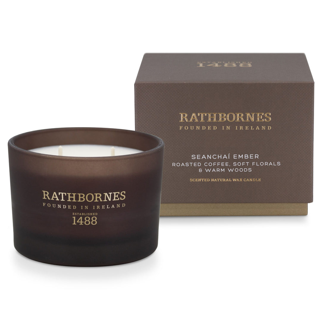 Rathbornes Seanchaí Ember (Roasted Coffee, Soft Florals & Warm Woods) classic scented candle beside its mocha brown gift box