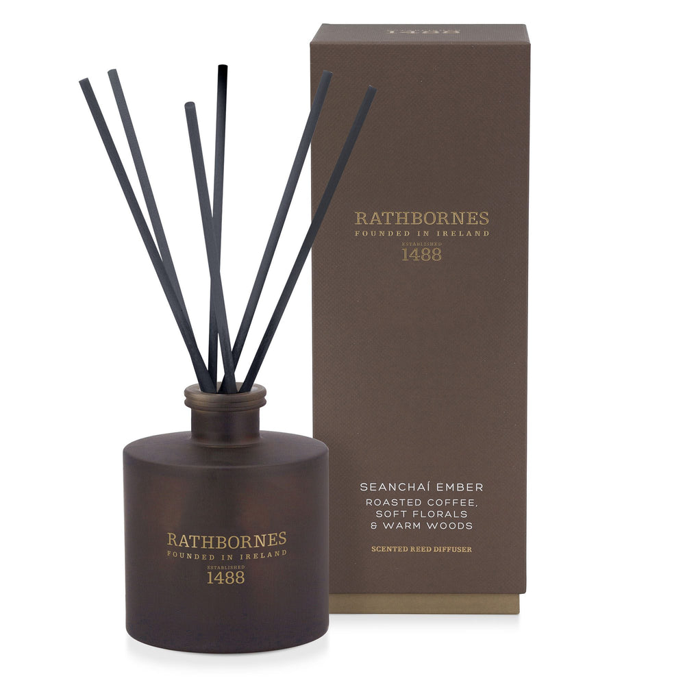 Rathbornes Seanchaí Ember (Roasted Coffee, Soft Florals & Warm Woods) scented reed diffuser with reeds, beside its gift box