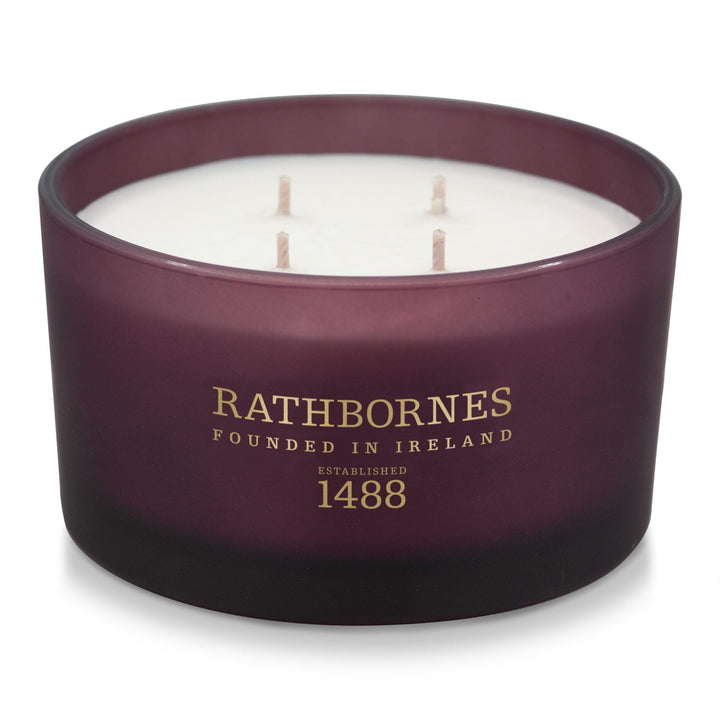 Rathbornes Seanchaí Dún (Ripe Fig, Aged Leather & Sheltering Woods) luxury 4 wick candle in plum glass