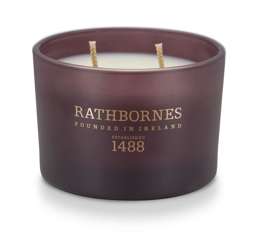 Rathbornes Seanchaí Dún (Ripe Fig, Aged Leather & Sheltering Woods) classic 2 wick candle in plum glass