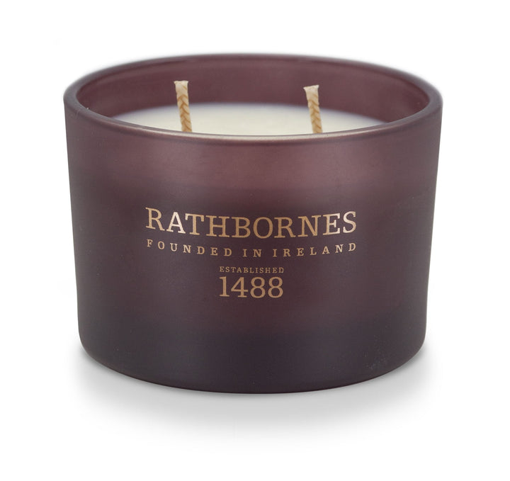 Rathbornes Seanchaí Dún (Ripe Fig, Aged Leather & Sheltering Woods) classic 2 wick candle in plum glass