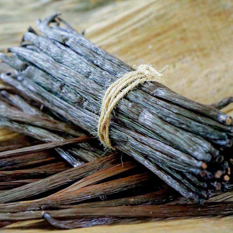 Bundle of dark cured vanilla pods tied with twine, the vanilla base note of the Rathbornes Seanchaí Dún candle